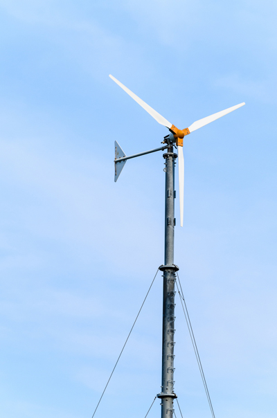 small Wind turbines on blue sky